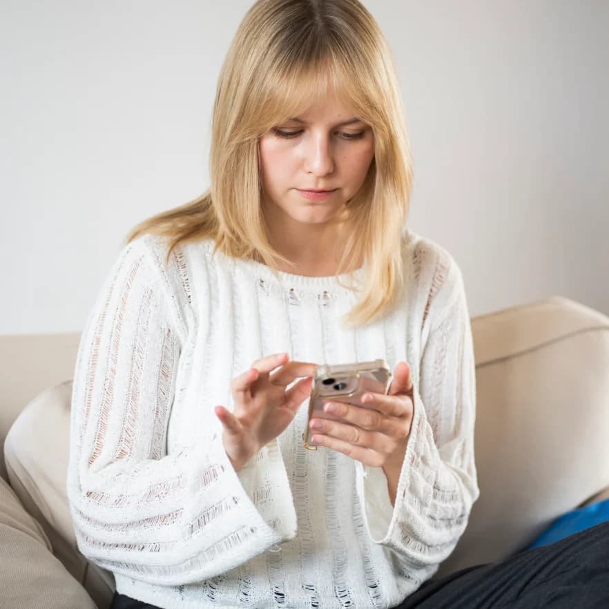 Kobieta patrząca w ekran telefonu