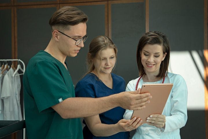 A general practitioner and medical assistants looking at test results